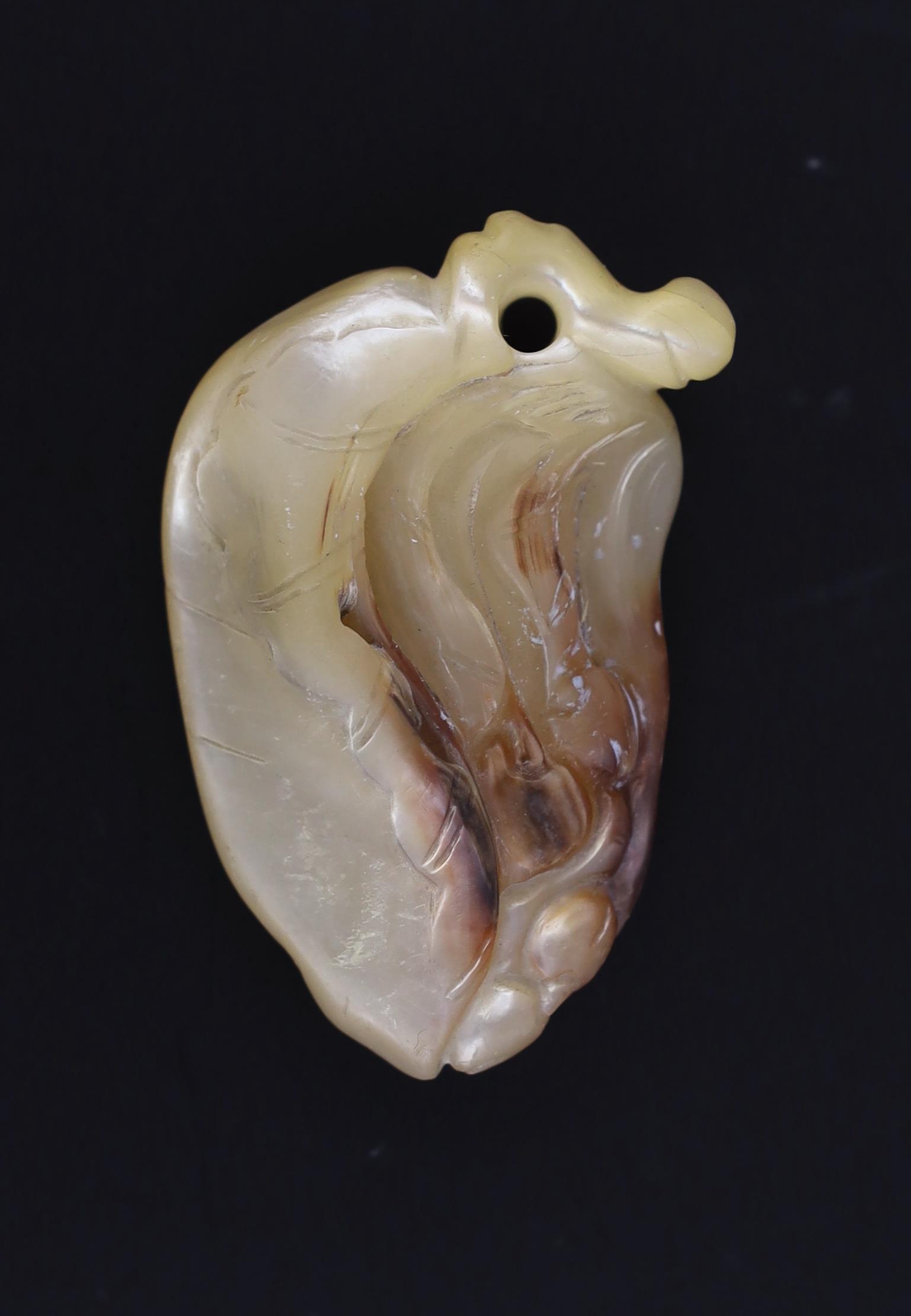 A Japanese mother of pearl netsuke of a leaf and berries, ridden by a bat and a spider, Meiji period